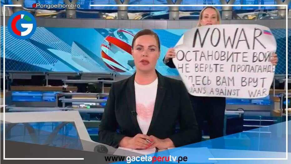Una mujer se muestra en noticiero ruso con una pancarta en contra de la Guerra